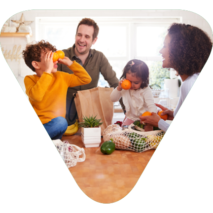 Triangle with a family in the kitchen having fun unloading the groceries
