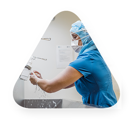 medical professional washing hands in a hospital setting