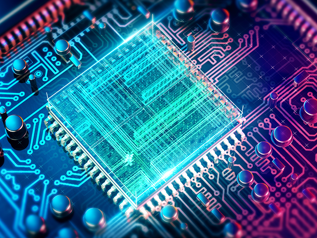 A light blue microchip on a blue and pink motherboard