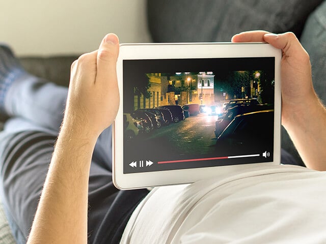 Person viewing entertainment media on a tablet