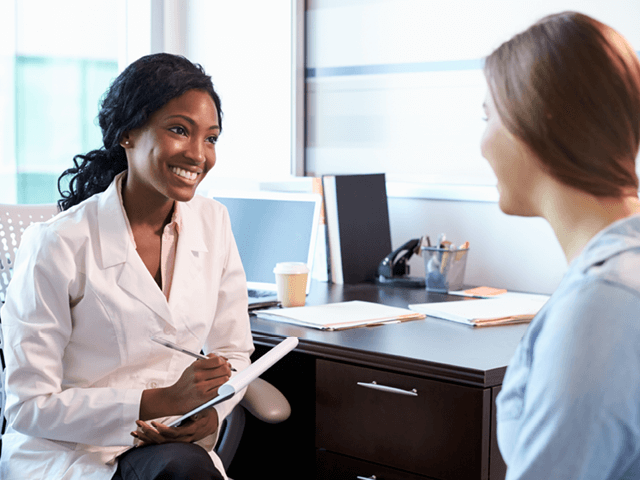 Two women discussing employment benefits