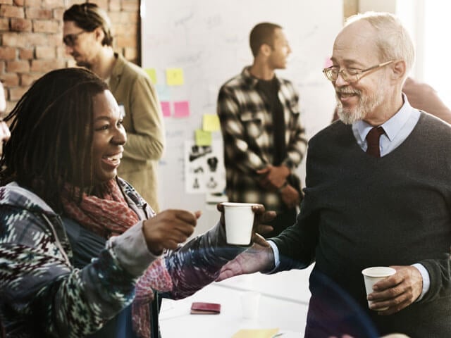 Experienced business and IT professionals communicating in an office