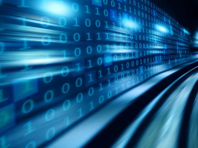 A set of blue monochromatic tracks running along a wall displaying binary data