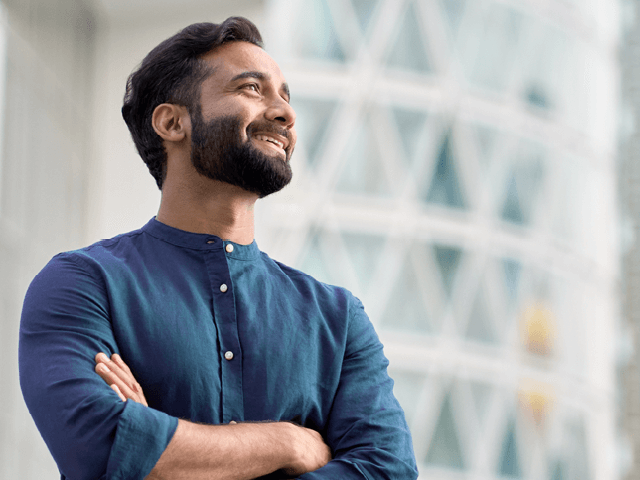 A smiling man experiencing career growth potential
