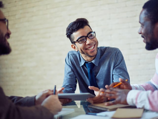 Recruiters sitting around a table and having a conversation