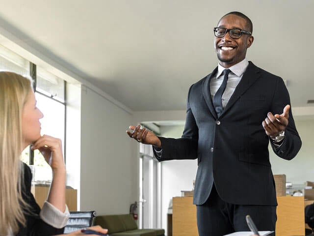 Recruiting and sales professionals communicating in an office