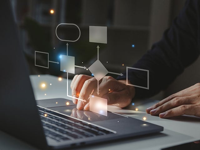 hands typing on laptop validating work