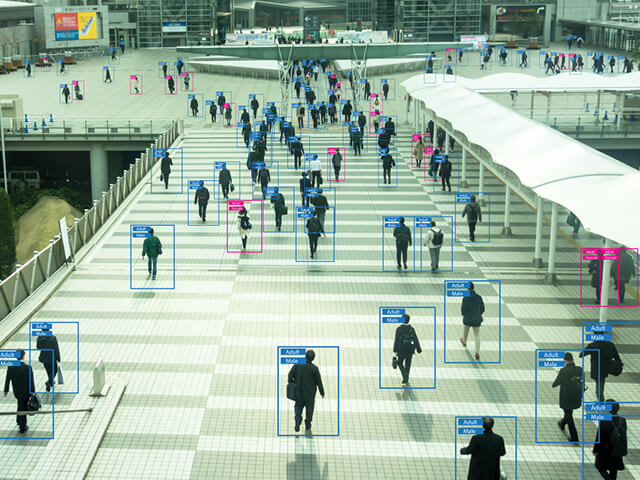 people walking across a bridge using technology and ai machine learning so understand each individual