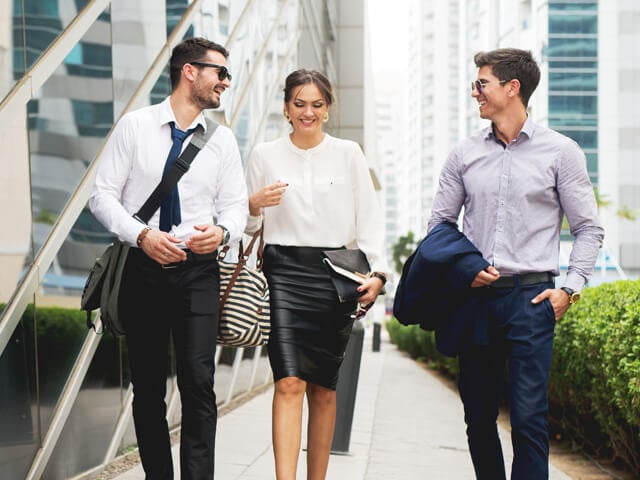 College students and recent graduates walking together and discussing careers