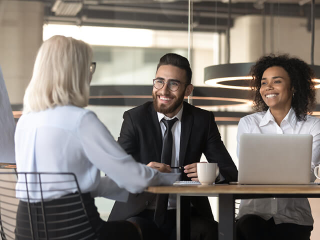 Three people discussing DEI and equitable recruiting
