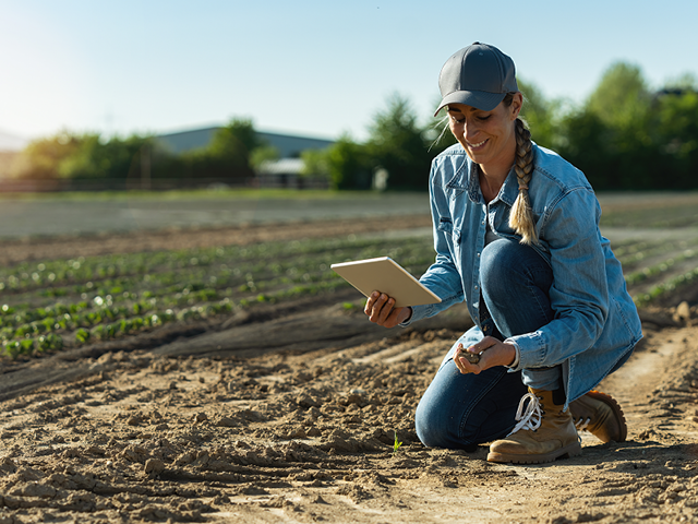 woman farmer checking her soil