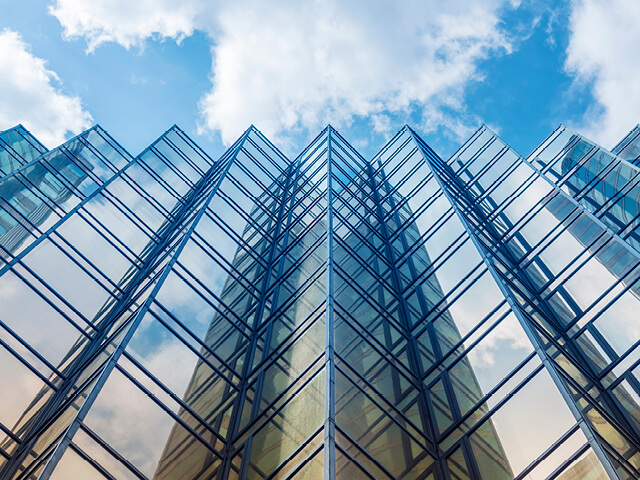 view from the ground of a glass highrise building