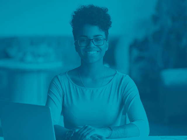 A smiling Per Scholas student