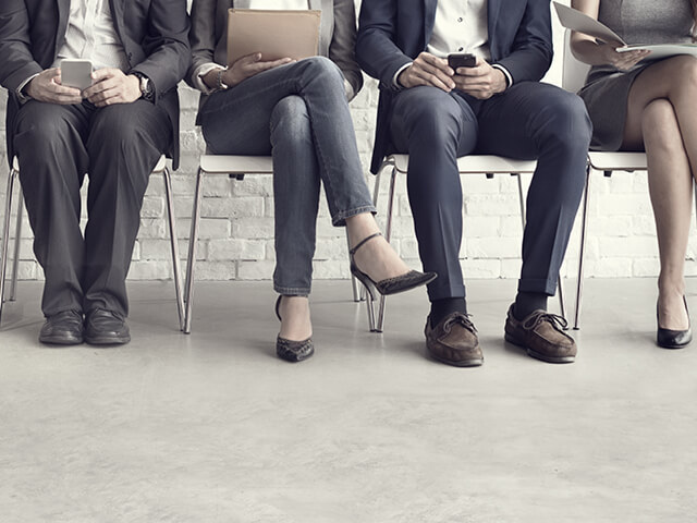 four business professionals seated and waiting for their chance to advance the workforce in their industry