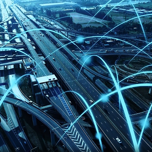 Aerial view of a complex freeway interchange with glowing digital lines overlaying the roads.