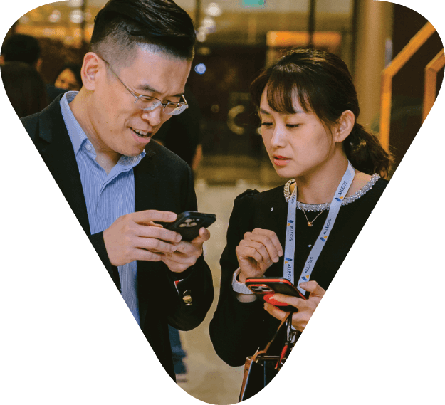 two employees reviewing content on their mobile phones together, collaborating. 