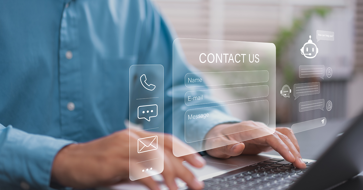 Person using a laptop with online contact form icons
