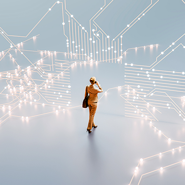 Person standing in a glowing digital landscape with circuit-like lines surrounding them.