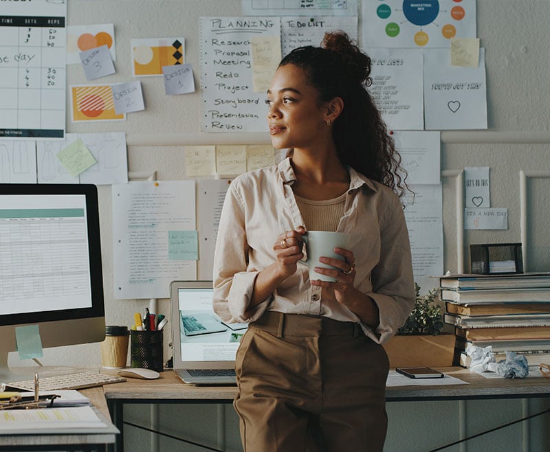 Woman standing holding coffee mug