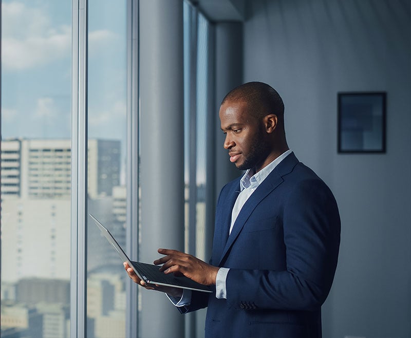 man checking finances on laptop