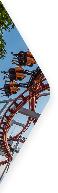 People riding a rollercoaster that hangs the riders down