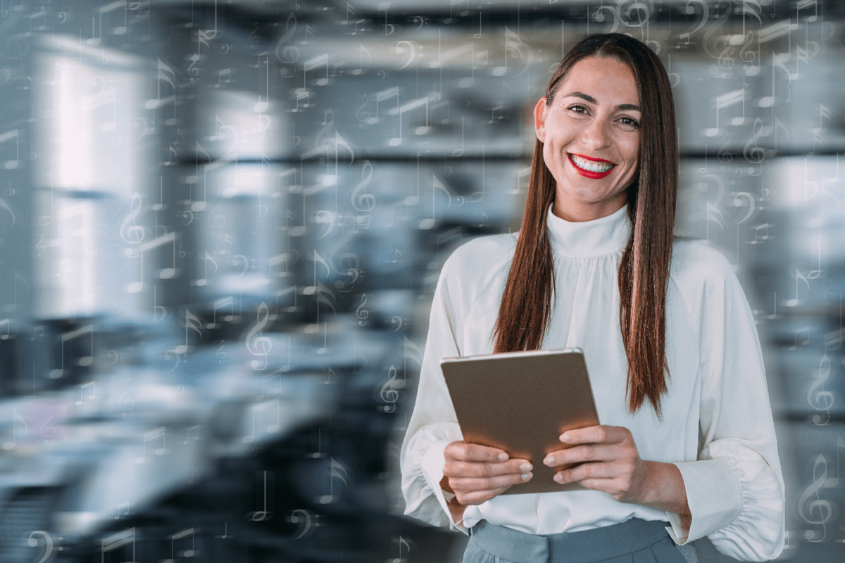 Business professional holding a table smiling at camera. White music notes overlay