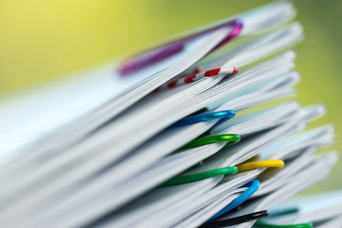Stack of paper with colorful paperclips