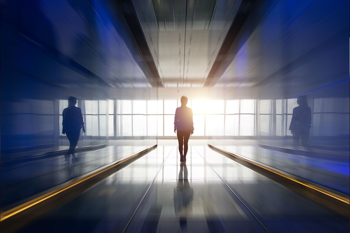 man in suit walking down a dark hallway