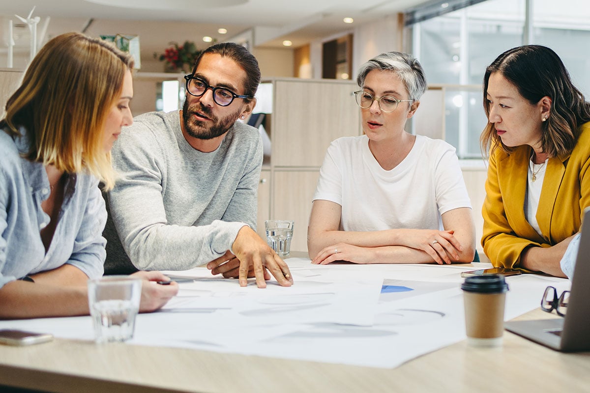 group of people sitting at a table discussing data strategy
