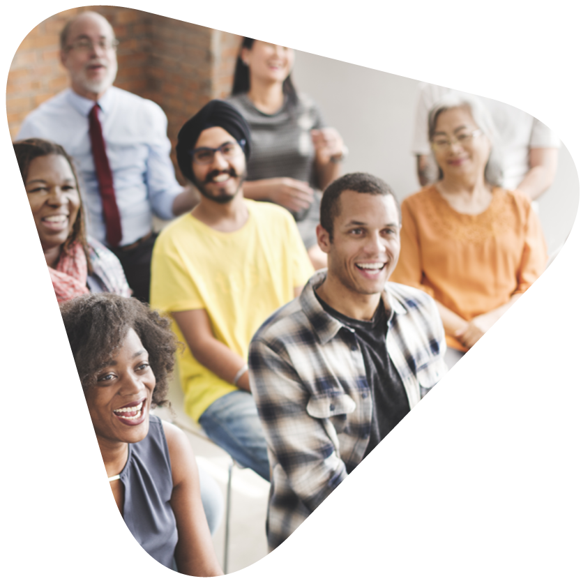 a diverse group sitting together smiling in a triangle image