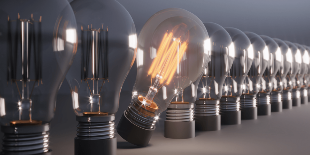 Row of switched off light bulbs with one switched on. Concept of having a standout amoung others.