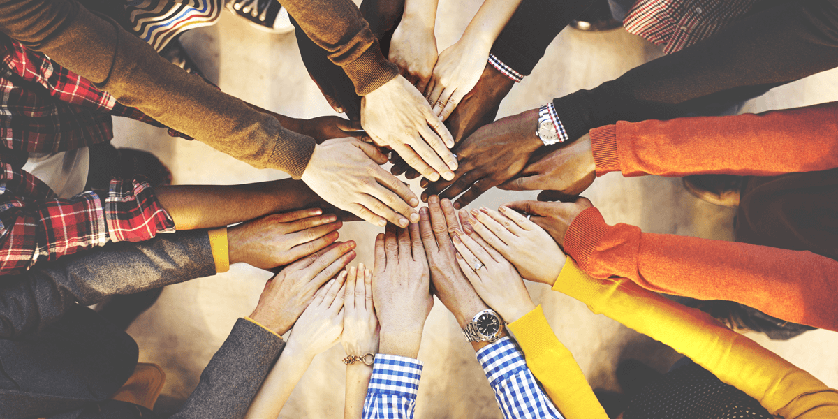 Diverse hands in a group celebrating