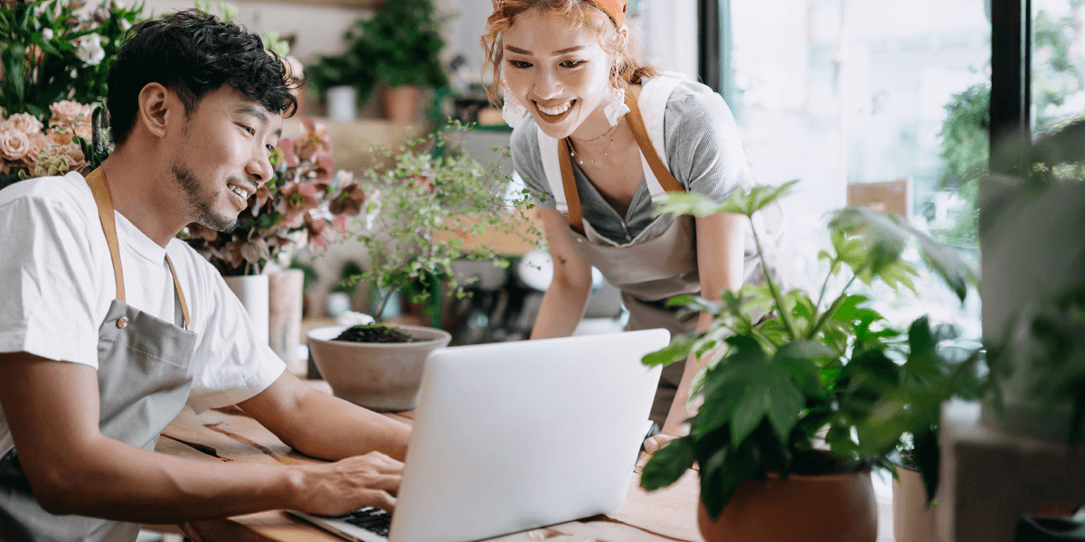 Two people sharing a laptop
