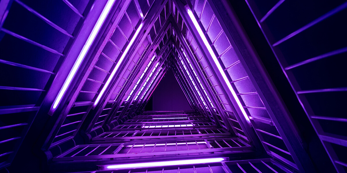 bright neon purple tubes arranged in a long triangular shape. 