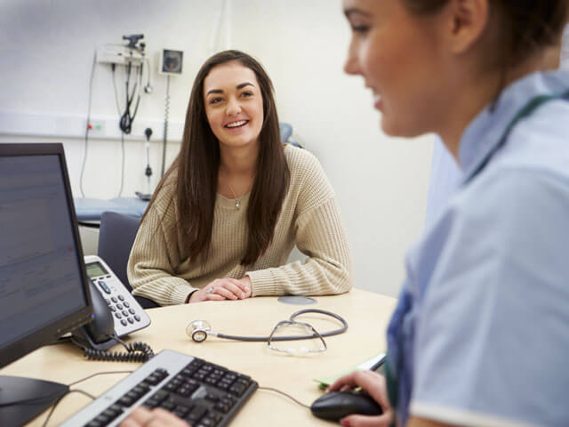 a patient discussing healthcare with a nurse