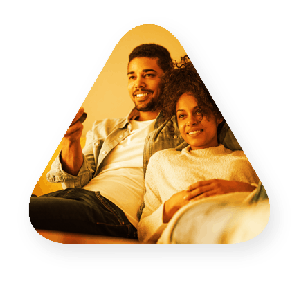 a man and a woman changing the channel with a remote