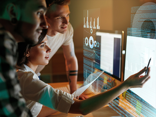a team looking at a monitor reviewing their Amazon EMR migration