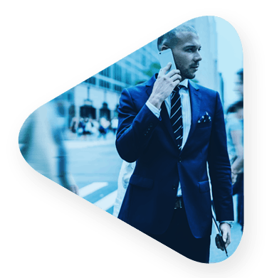 a well dressed man walking on the phone