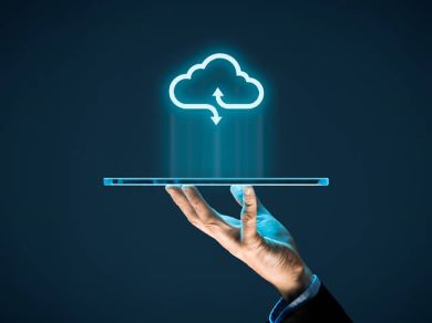 open palm hand balancing a laptop projecting a cloud enablement icon, image