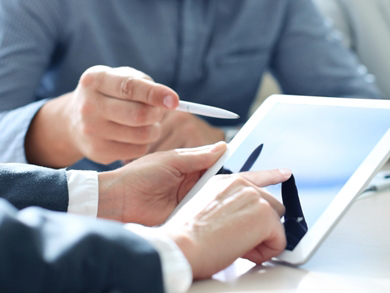 two people try to improve data quality on a tablet