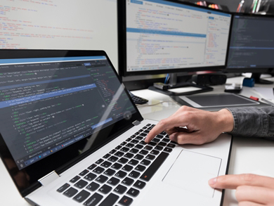 devops engineer working on multiple computer screens