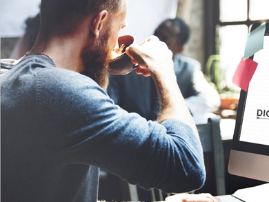 male digital marketing professional drinks coffee
