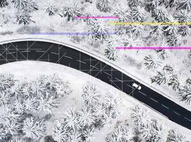 birds eye view of snow covered country road with digital data overlay