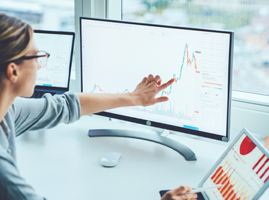 professional woman at computer analyzing raw data