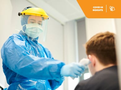 Clinician tends to a paitent while wearing proper protective gear