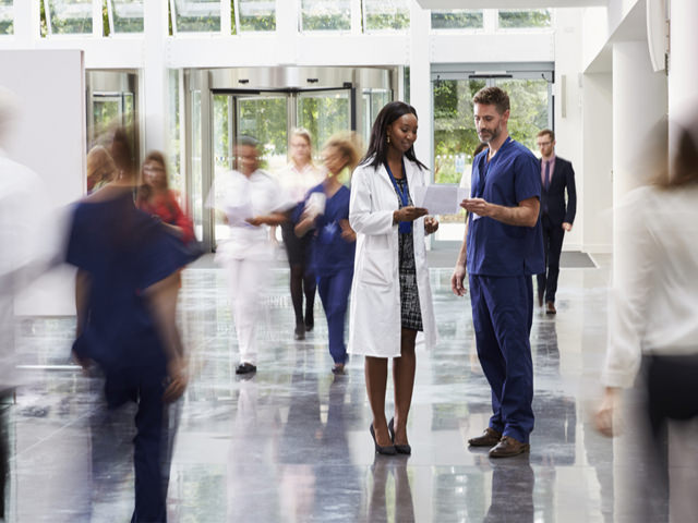 people examine demand forecasts at a busy hospital