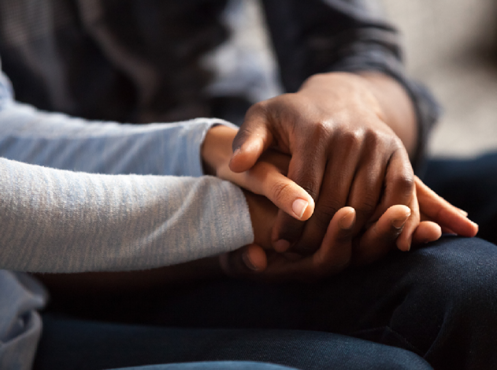 colleagues comfort one another by holding hands during difficult, racial and diversity discussions
