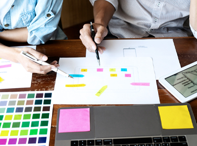 two professionals reviewing resumes and protfoilios in order to build personal brand