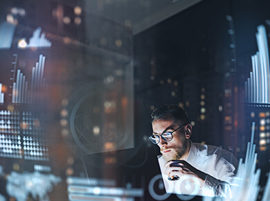 CaaS, FaaS, and PaaS professional surounded by multiple screens dilled with data graphics and stats