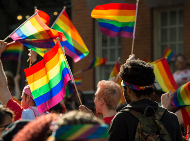 rainbow flags waving at a pride parade